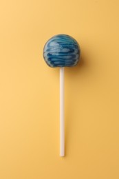 Photo of Tasty lollipop on orange background, top view