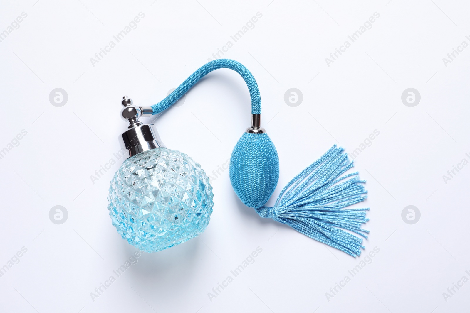 Photo of Bottle of perfume on white background, top view