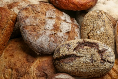 Photo of Different kindsdelicious bread as background, closeup