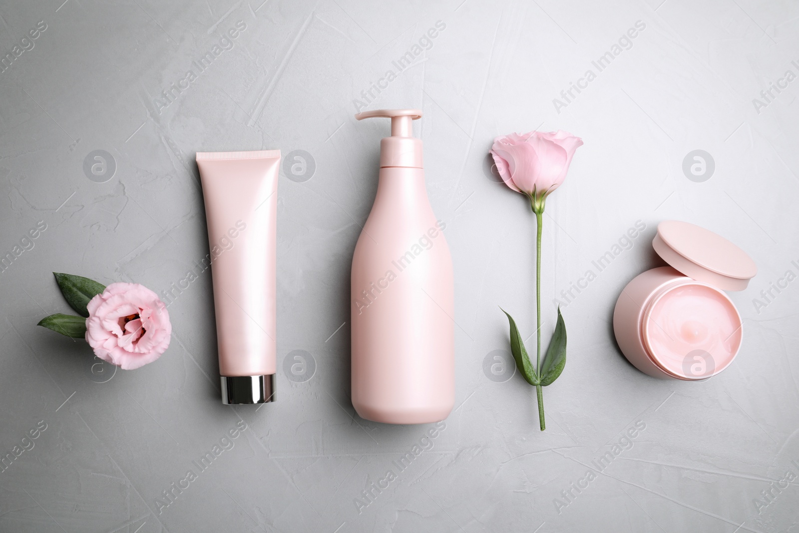 Photo of Flat lay composition with hair cosmetic products on grey stone table