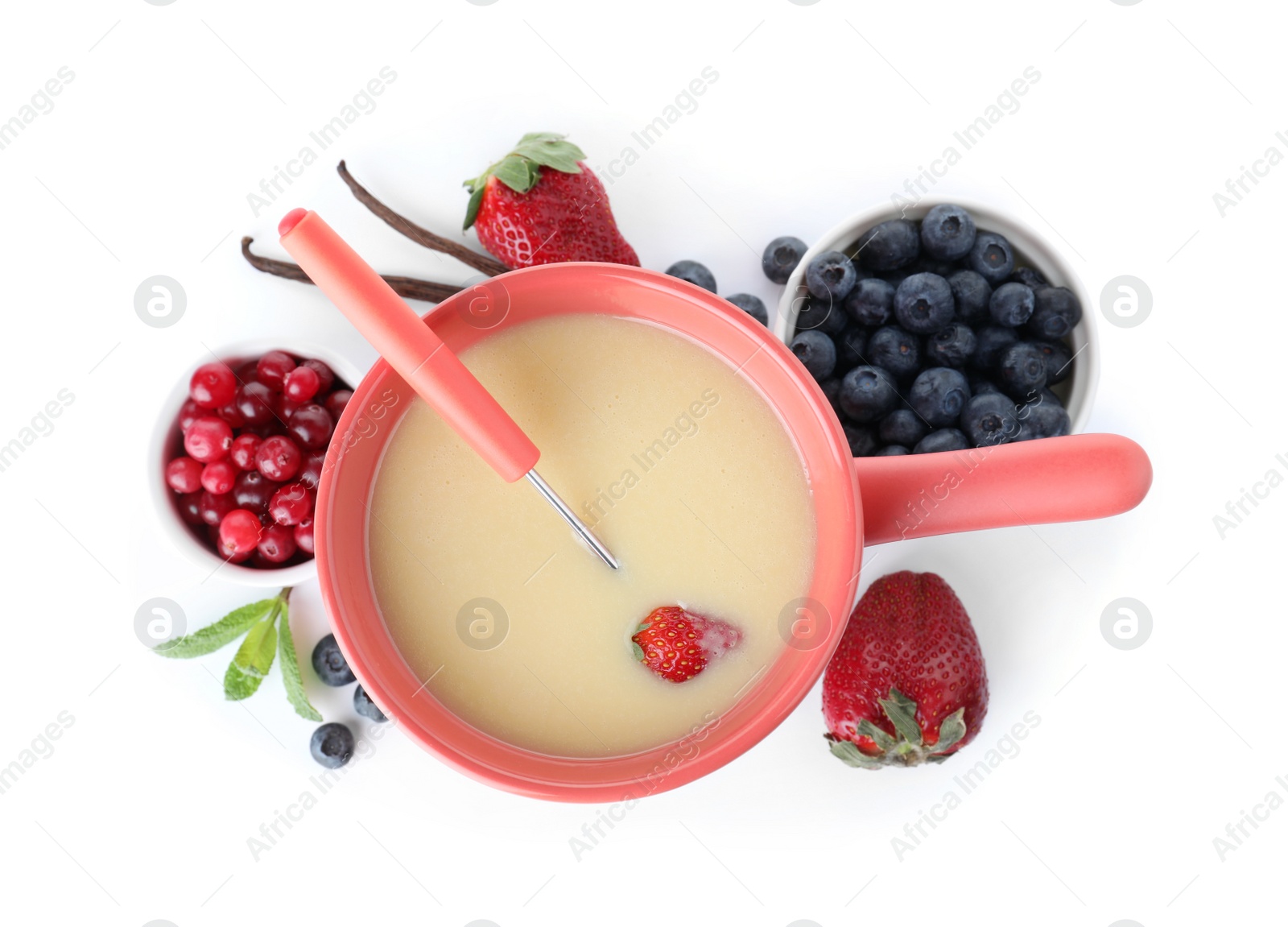 Photo of Fondue pot with chocolate and berries on white background, top view