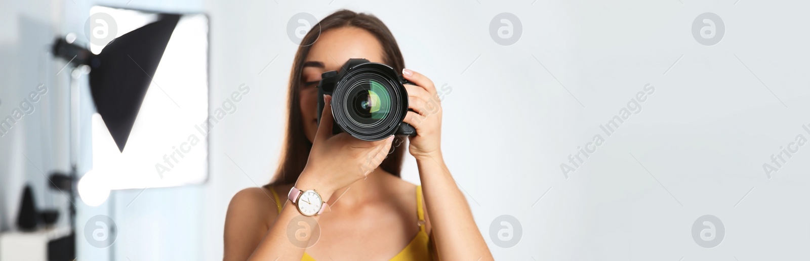 Image of Professional photographer with camera in studio, space for text. Banner design