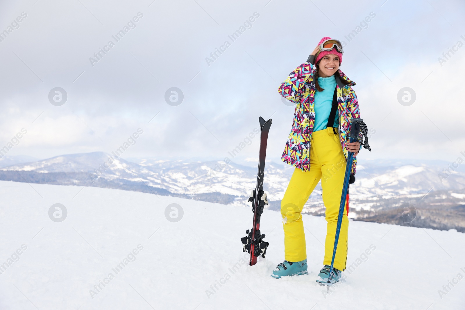 Photo of Young skier wearing winter sport clothes outdoors