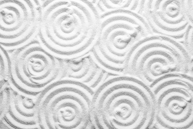 Photo of White sand with pattern as background, top view. Zen, meditation, harmony