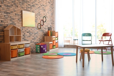 Photo of Stylish child room interior with colorful furniture