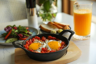 Tasty Shakshouka served on white table. Traditional Arabic dish