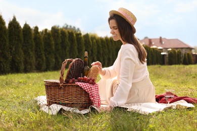 Photo of Happy woman having picnic in green park