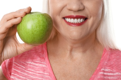 Smiling woman with perfect teeth and green apple on white background, closeup