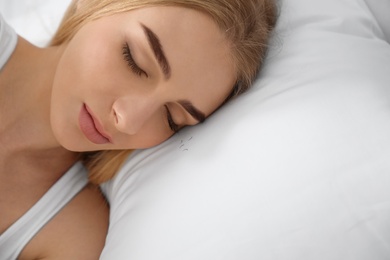 Photo of Sleeping woman and fallen eyelashes on pillow