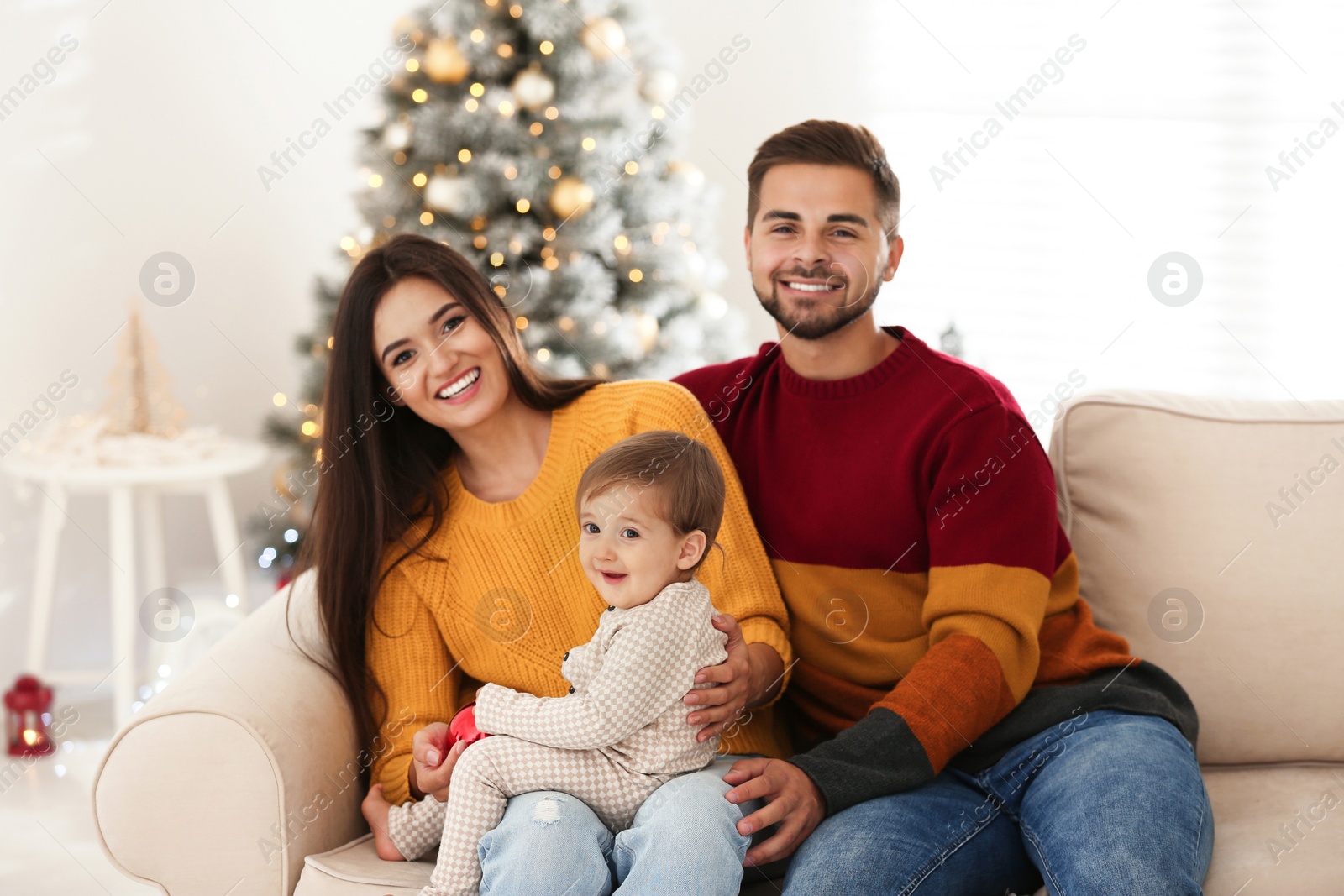 Photo of Happy family with cute baby at home. Christmas celebration