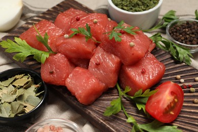 Photo of Raw beef meat and different ingredients for cooking delicious goulash on table, closeup