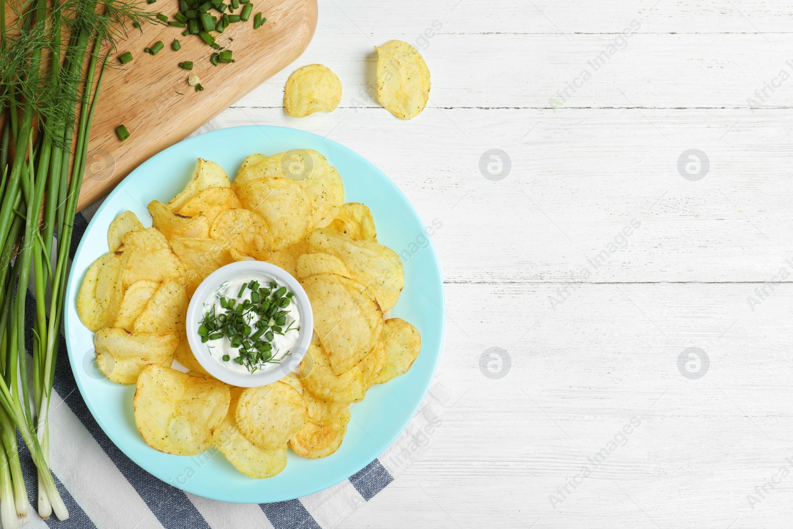 Photo of Chips with sour cream on white wooden background, flat lay. Space for text