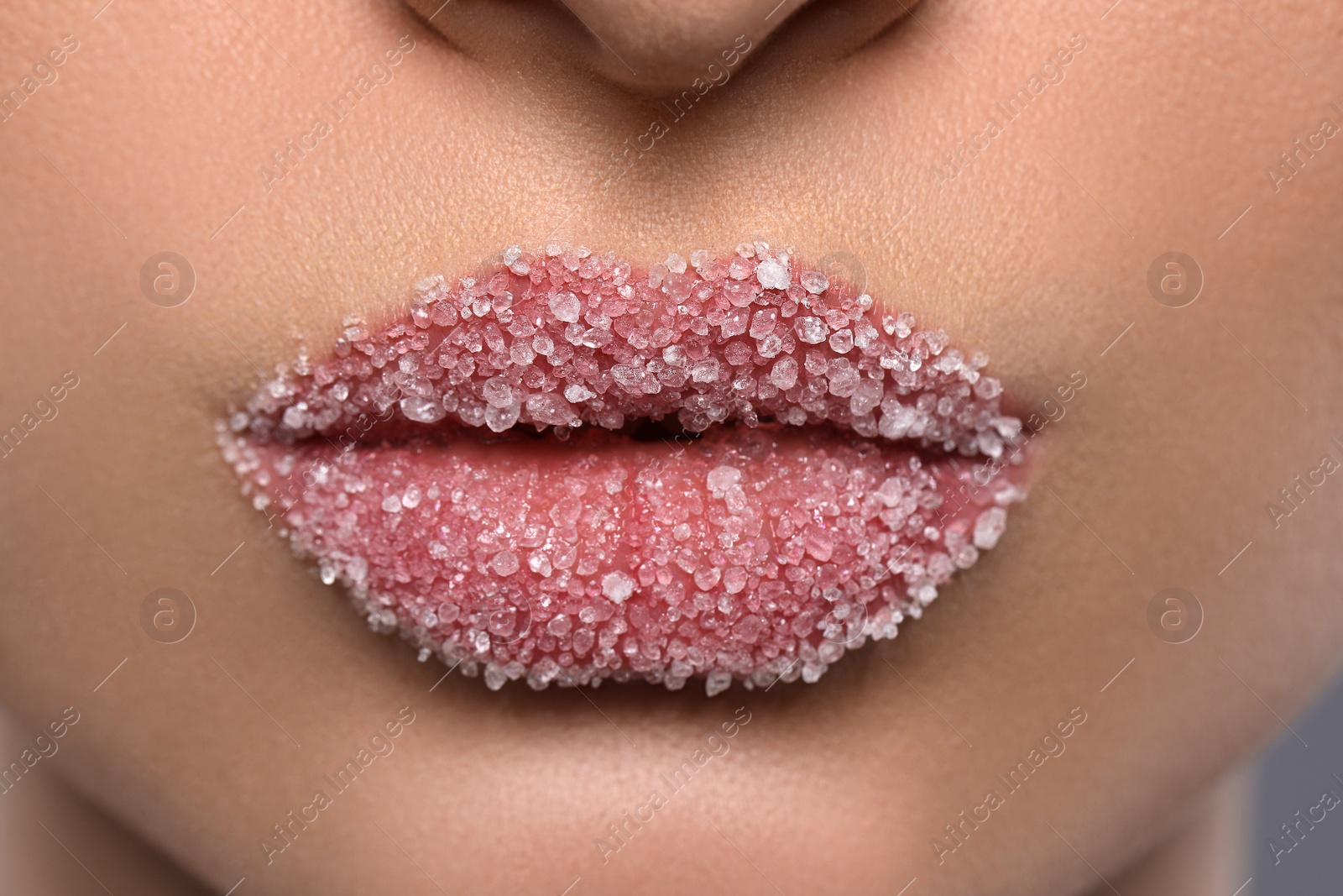 Photo of Woman with beautiful plump lips covered in sugar, closeup