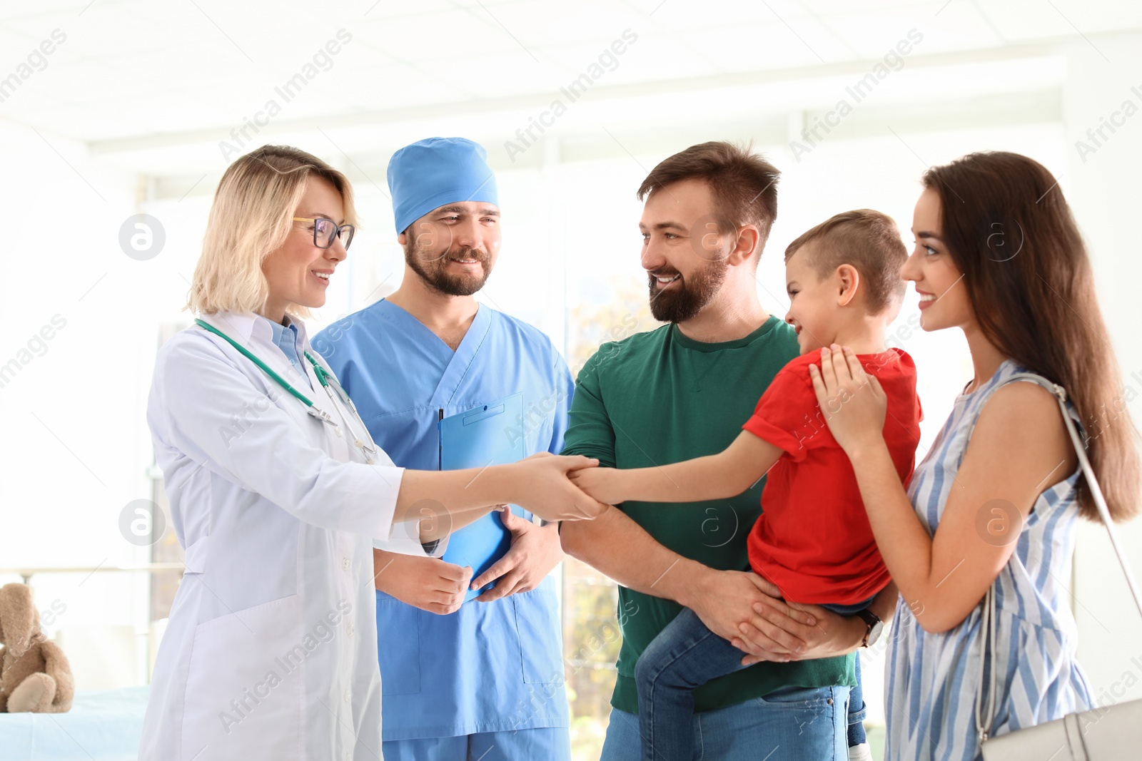 Photo of Little boy with parents visiting children's doctors in hospital