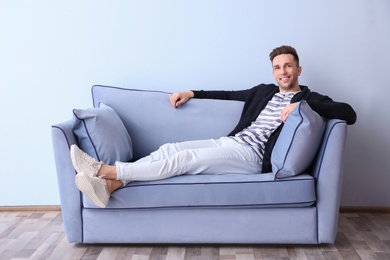 Handsome young man on sofa, indoors