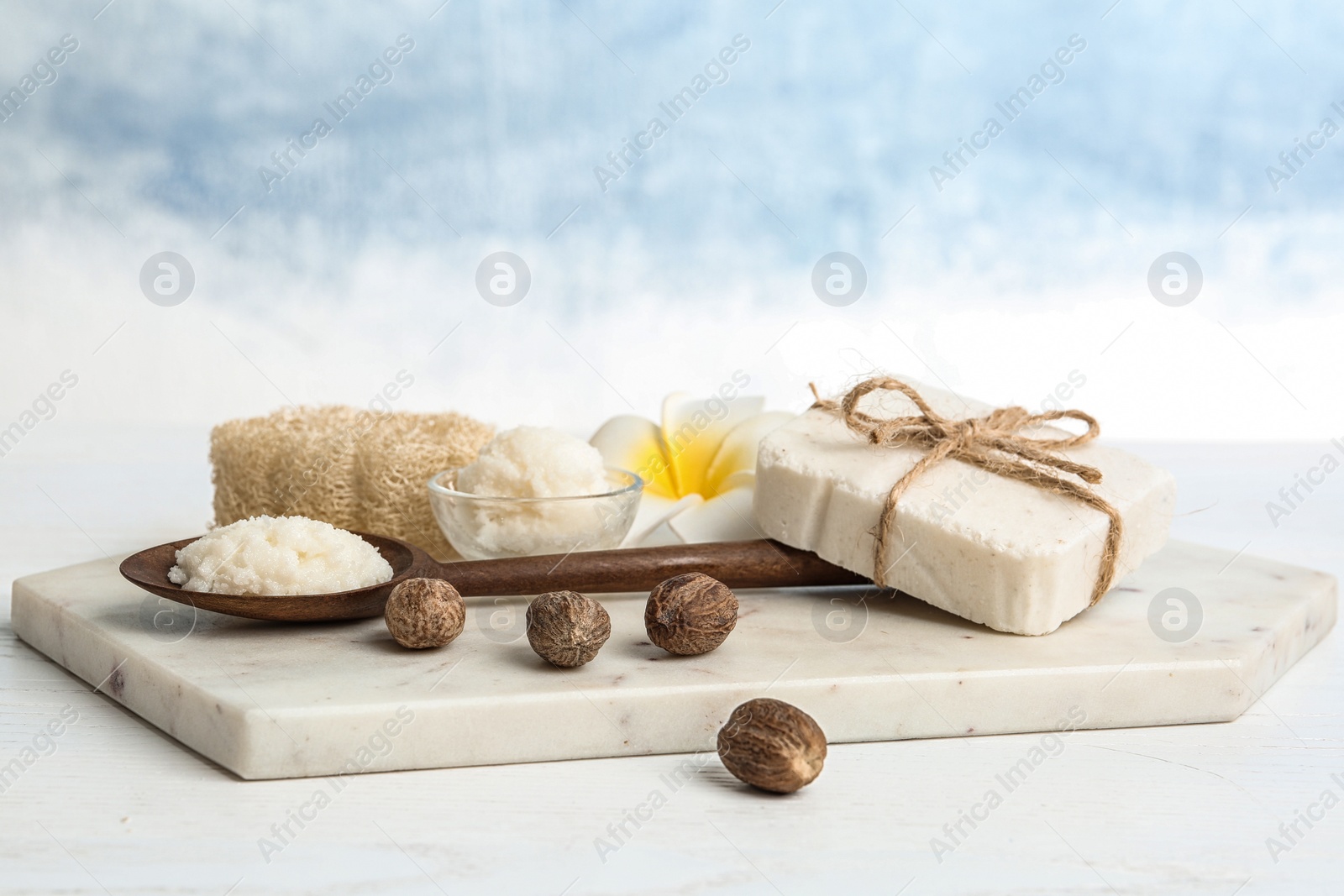 Photo of Composition with Shea butter and nuts on table against color background. Space for text