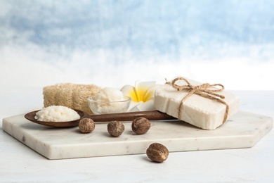 Composition with Shea butter and nuts on table against color background. Space for text