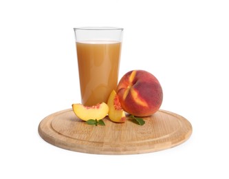 Photo of Wooden tray with glass of delicious peach juice, fresh fruits and leaves isolated on white