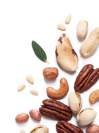 Different delicious nuts on white background, flat lay. Space for text