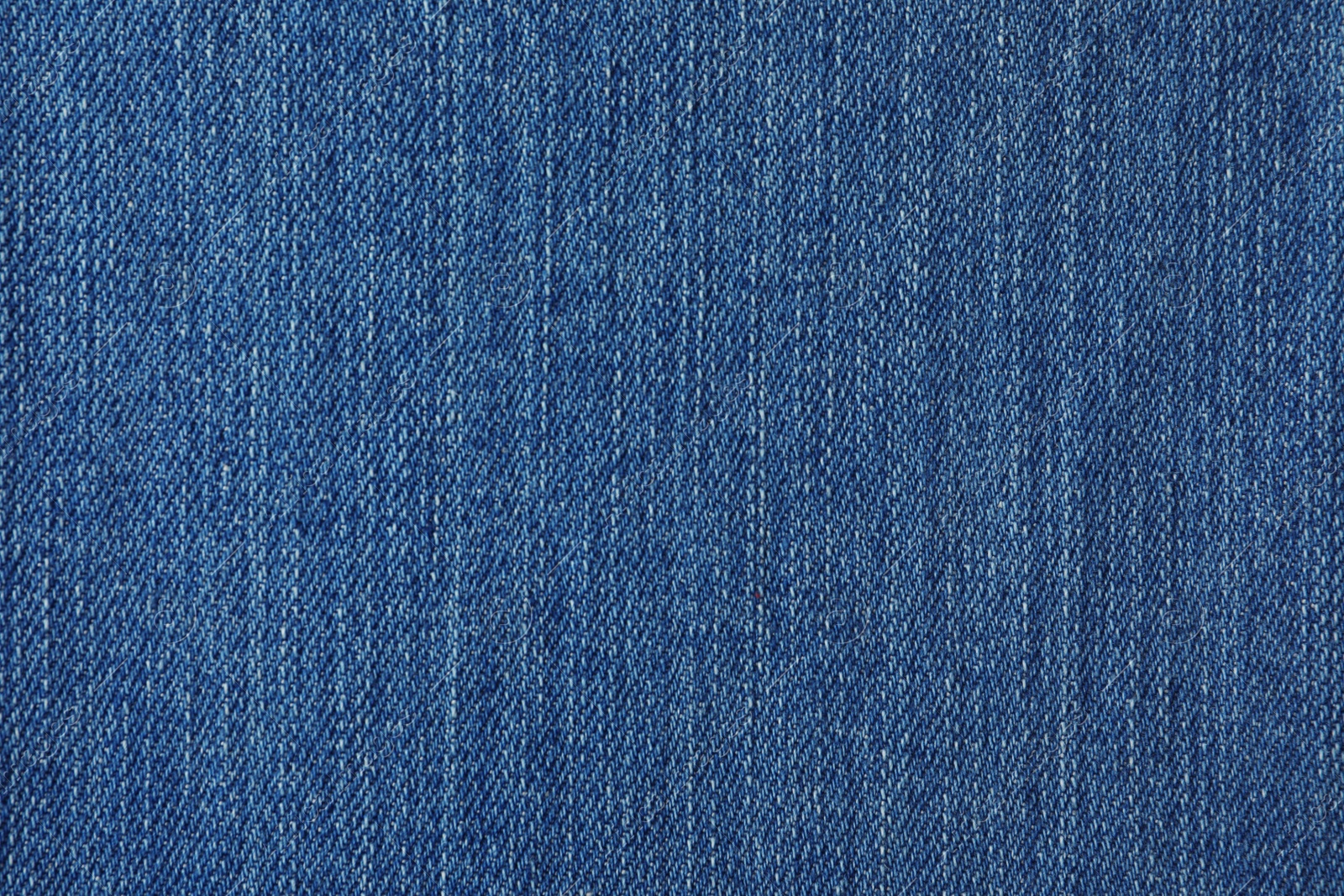 Photo of Texture of blue jeans as background, closeup