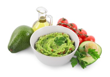 Delicious guacamole and ingredients isolated on white