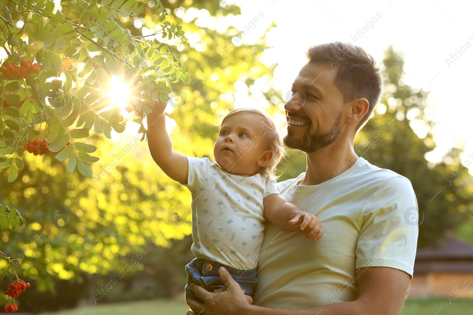 Photo of Happy father with his cute daughter in park on sunny day