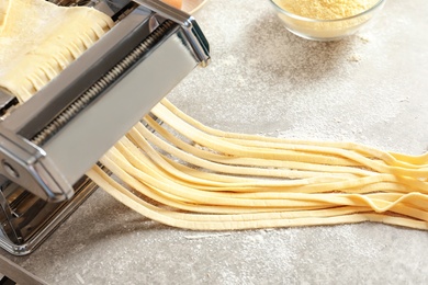 Pasta maker with dough on kitchen table