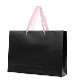 Photo of Paper shopping bag with handles on white background. Mockup for design