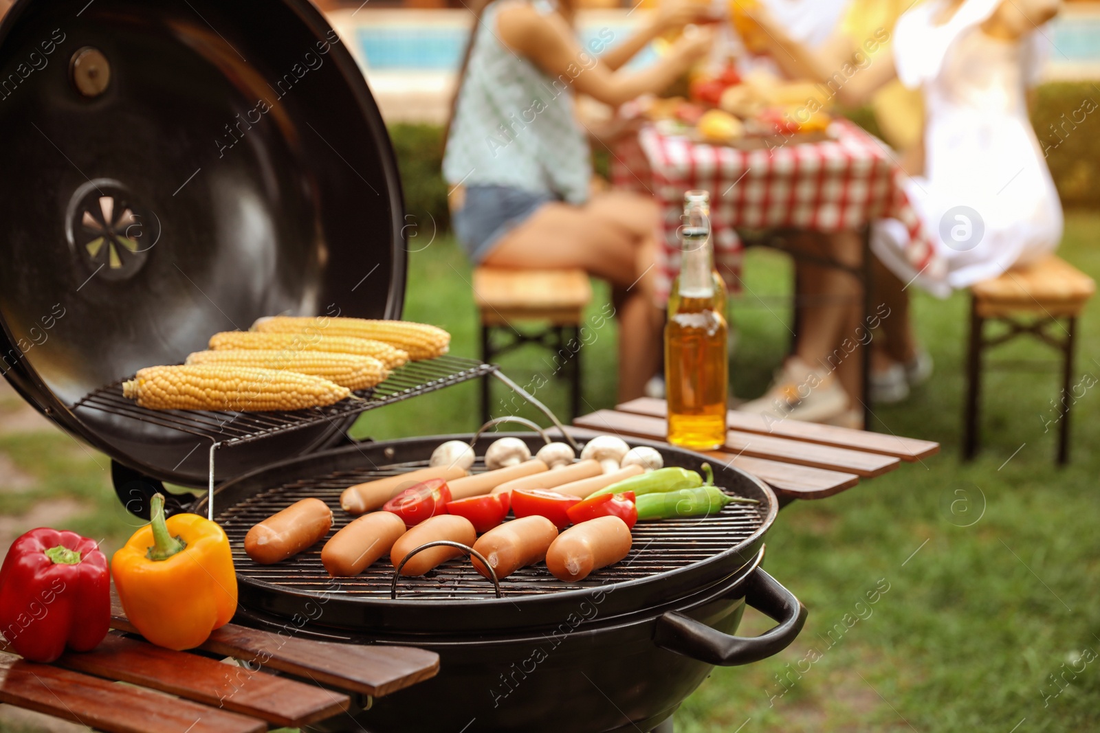 Photo of Barbecue grill with tasty fresh food outdoors