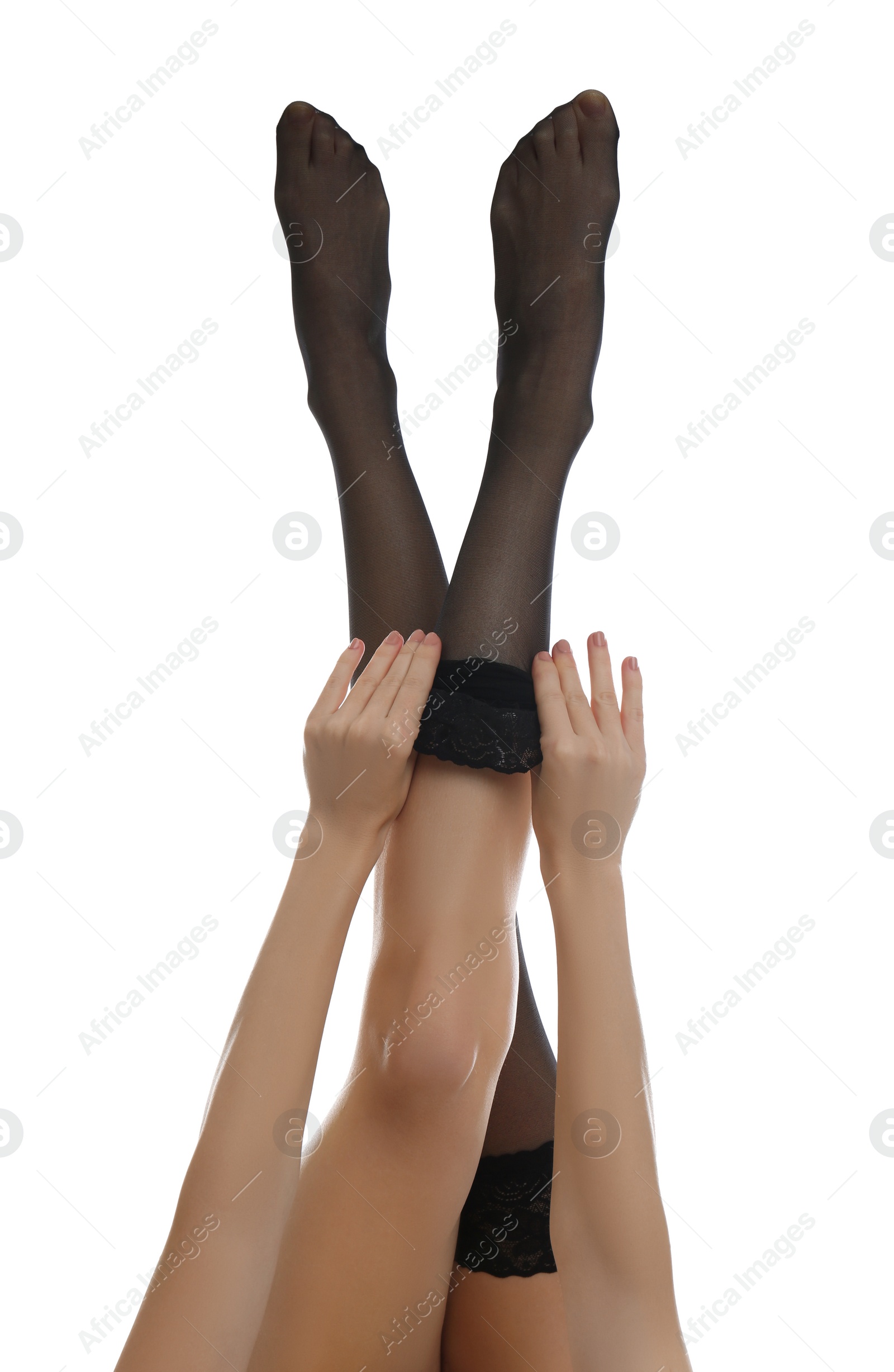 Photo of Young woman putting on stocking against white background, closeup