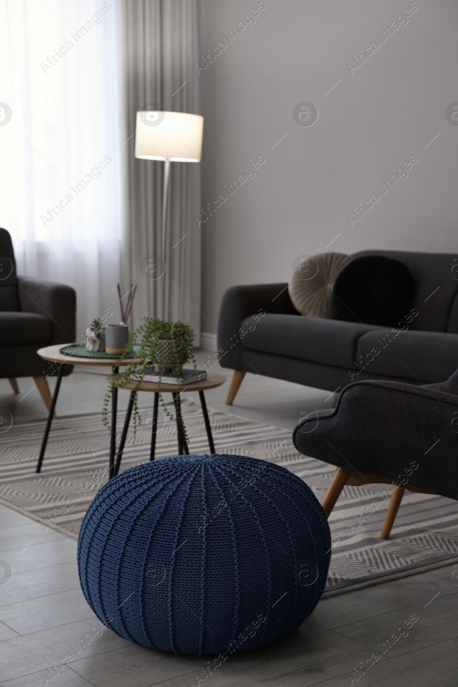 Photo of Stylish comfortable poufs and sofa in room. Home design