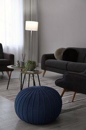 Stylish comfortable poufs and sofa in room. Home design