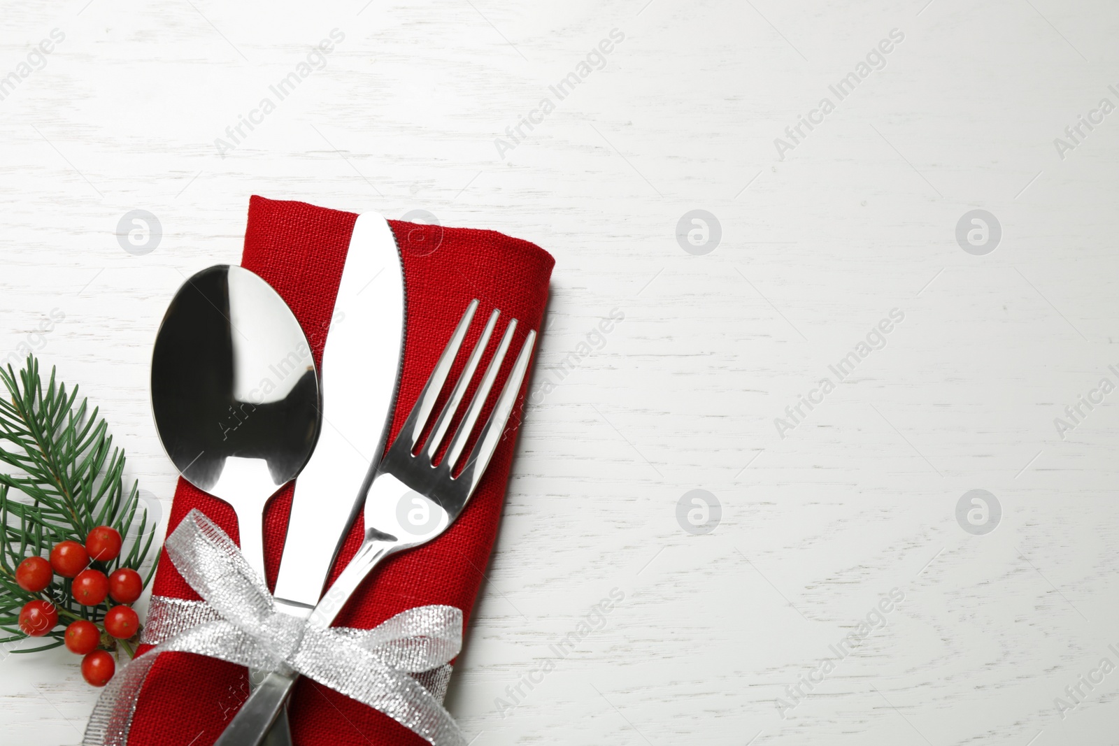 Photo of Cutlery set on white wooden table, top view. Space for text