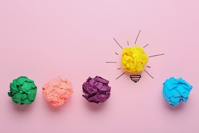Photo of Composition with crumpled paper ball as lamp bulb on pink background, flat lay. Idea concept