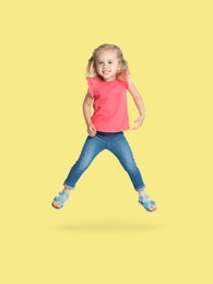 Image of Happy cute girl jumping on beige background