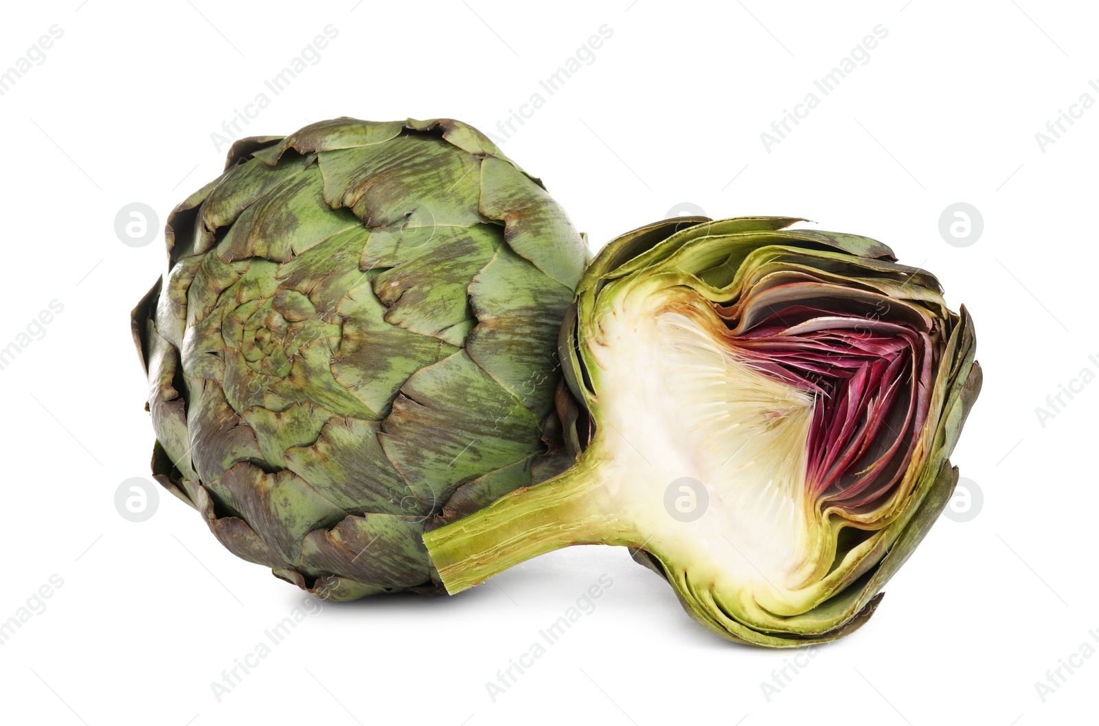 Photo of Cut and whole fresh artichokes on white background