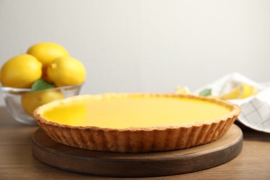 Photo of Delicious homemade lemon pie on wooden table