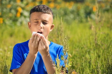 Little boy suffering from ragweed allergy outdoors