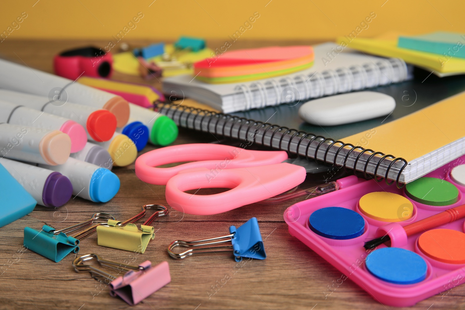 Photo of Many different school stationery on wooden table, closeup. Back to school