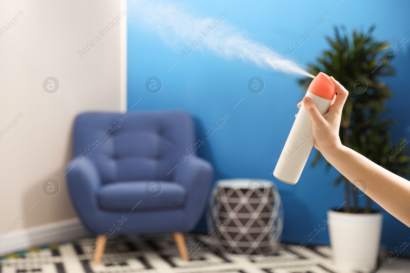 Photo of Woman spraying air freshener at home, closeup