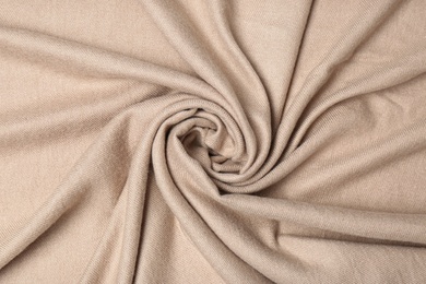 Photo of Soft beige cashmere fabric as background, closeup