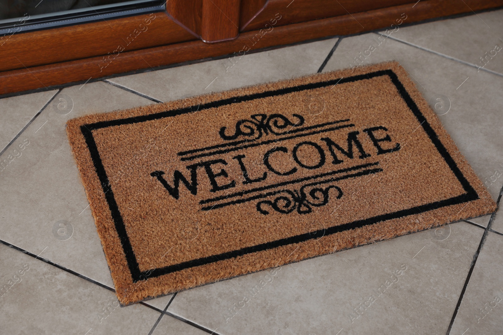 Photo of Door mat with word Welcome on floor