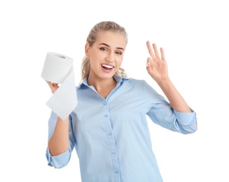 Beautiful young woman holding toilet paper roll on white background
