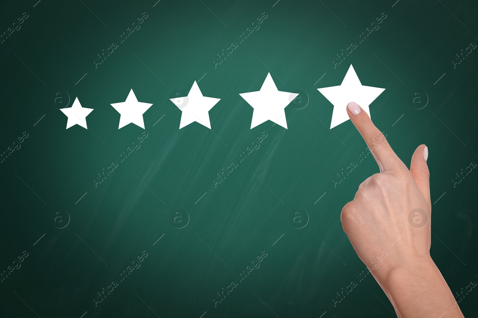 Image of Quality rating. Woman pointing at stars on chalkboard, closeup