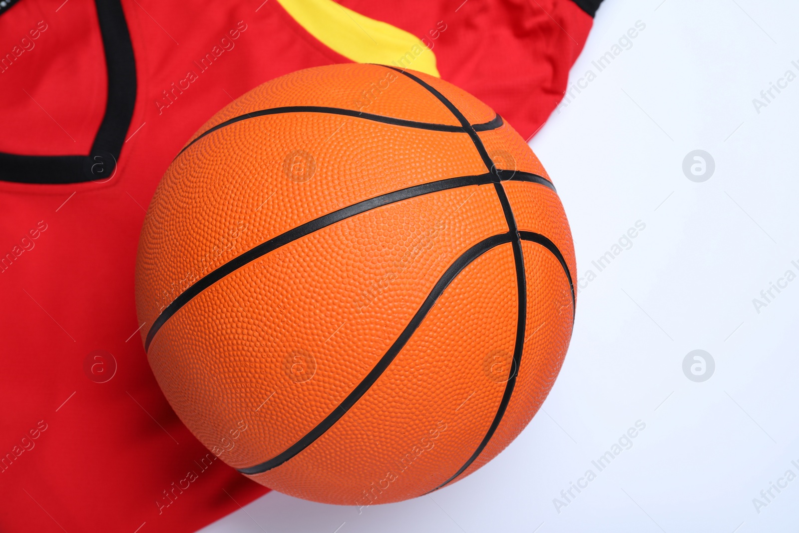 Photo of Basketball uniform and ball on white background, top view