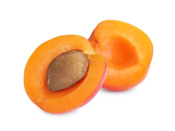 Halves of delicious ripe apricot on white background