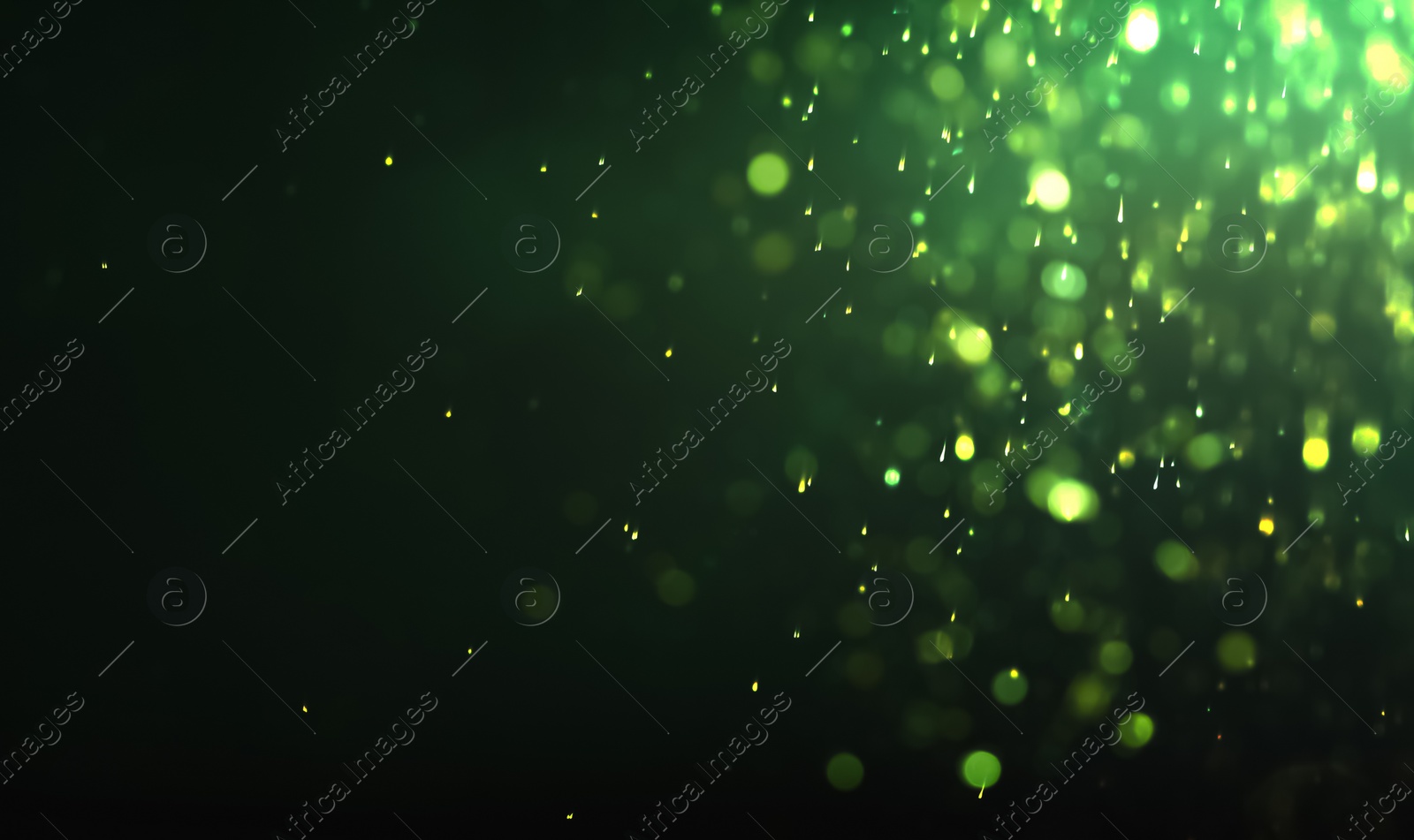 Photo of Blurred view of festive lights on green background. Bokeh effect