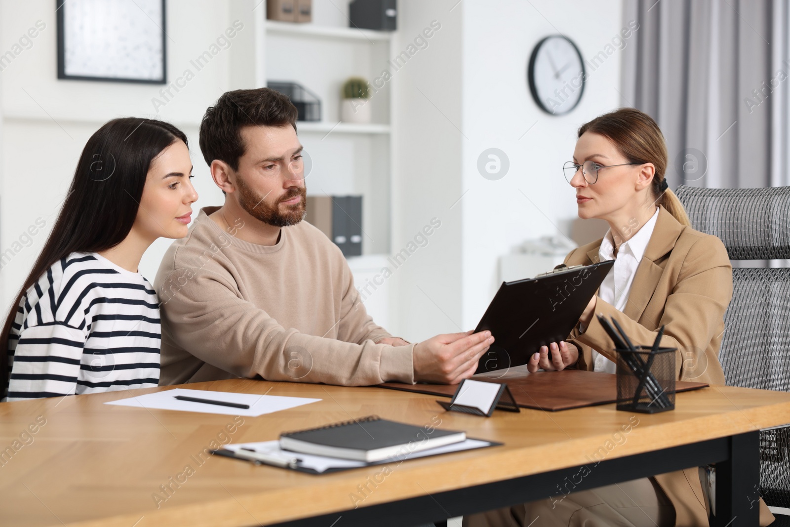 Photo of Couple having meeting with lawyer in office