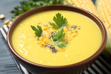 Photo of Delicious creamy corn soup on table, closeup