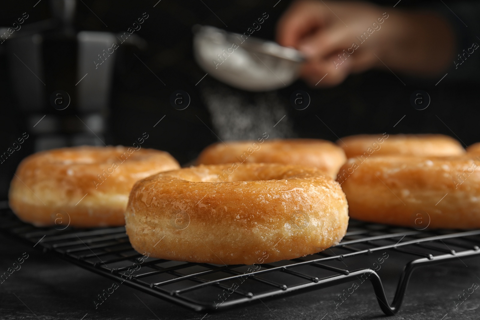 Photo of Sweet delicious glazed donuts on black table